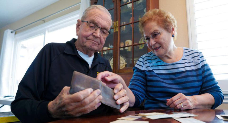 Paul Grisham (left) with his wife Carole Salazar (right) and the wallet he lost 53 years ago