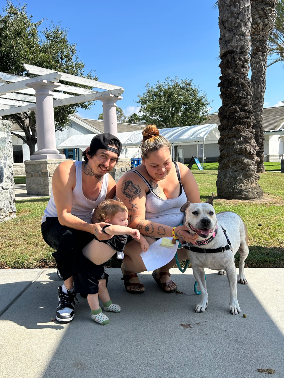 Cinderella, a 6-year-old pit bulll mix, and her new family. Photo from spcaLA