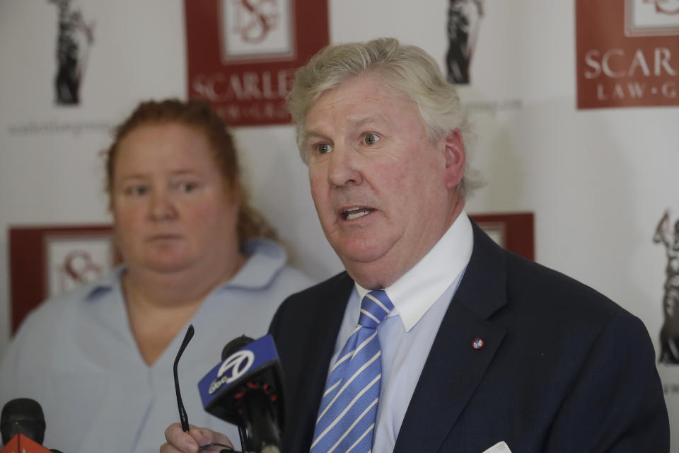 Attorney Randall Scarlett, right, attorney for Wendy Towner, left, speaks at a news conference in San Francisco, Tuesday, Nov. 12, 2019. Towner is one of the plaintiffs in a lawsuit that alleges that negligent security measures allowed a gunman to sneak in and fatally shoot three people and wound 13 others at a popular Northern California food festival last summer. (AP Photo/Jeff Chiu)