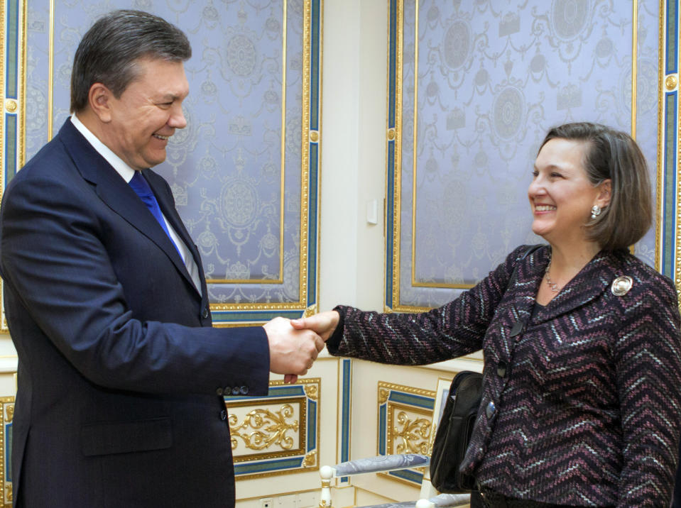 FILE - In this Feb. 6, 2014, file photo, Ukraine's President Viktor Yanukovych, left, greets U.S. Assistant Secretary for European and Eurasian Affairs Victoria Nuland, in Kyiv, Ukraine, Thursday, Feb. 6, 2014. When Secretary of State Antony Blinken travels to Ukraine he’ll be carrying a tough anti-graft message and strong U.S. backing for the country’s response to Russian aggression. He’ll also be bringing along a familiar face in the Washington-Moscow tug-of-war over Ukraine: Victoria Nuland. The mere presence in Kyiv of Nuland, now the No. 3 State Department official, is likely to irritate Russia. (AP Photo/Mykhailo Markiv, Pool, File)