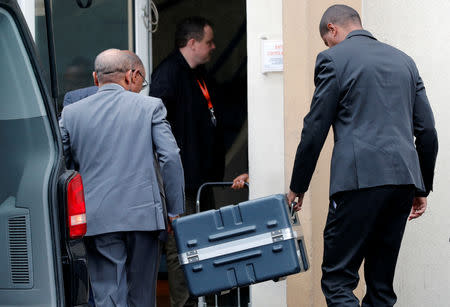 Men unload a case containing the black boxes from the crashed Ethiopian Airlines Boeing 737 MAX 8 outside the headquarters of France's BEA air accident investigation agency in Le Bourget, north of Paris, France, March 14, 2019. REUTERS/Philippe Wojazer