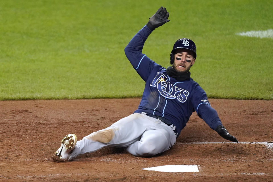 Tampa Bay Rays' Kevin Kiermaier slides home to score on a triple by Willy Adames during the fifth inning of a baseball game against the Kansas City Royals Tuesday, April 20, 2021, in Kansas City, Mo. (AP Photo/Charlie Riedel)