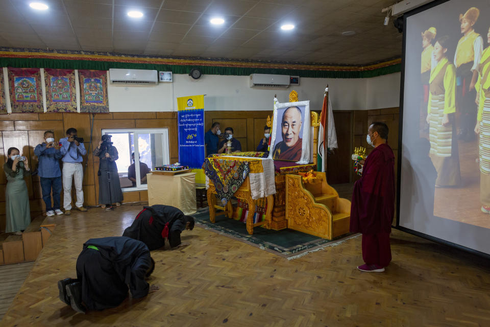 President of the Central Tibetan Administration Penpa Tsering, front corner, prostrates in front of a portrait of Tibetan spiritual leader the Dalai Lama during a ceremony to mark the 86th birthday of his leader in Dharmsala, India, Tuesday, July 6, 2021. (AP Photo/Ashwini Bhatia)