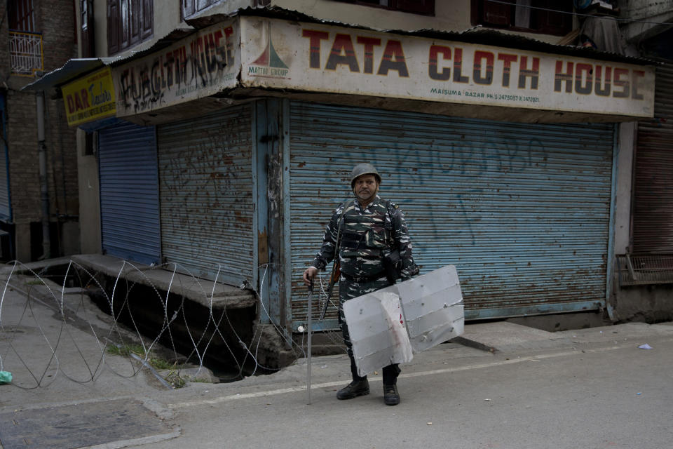 FILE - In this Aug. 9, 2019 file photo, an Indian Paramilitary soldier stands guard during curfew in Srinagar, Indian controlled Kashmir. Western countries are reeling from the coronavirus pandemic, awakening to a new reality of economic collapse, overwhelmed hospitals and home confinement. But for millions across the Middle East and in conflict zones elsewhere, much of this is familiar. Survivors of recent conflicts offer wisdom, such as stocking up on essentials, helping your neighbors and knowing that others have gone through much worse. (AP Photo/ Dar Yasin, File)