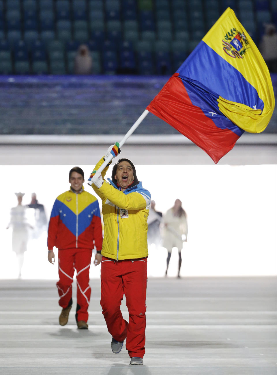 FILE - In this Feb. 7, 2014 file photo, Antonio Pardo of Venezuela carries a representation of his country's national flag as he leads the team during the opening ceremony of the 2014 Winter Olympics in Sochi, Russia. There have been Venezuelan athletes at past Winter Olympics, but Pardo is the first to enter an Alpine skiing event. (AP Photo/Mark Humphrey, File)