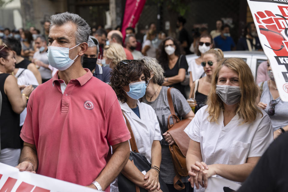 Medical workers take part in a rally outside the Greek Health Ministry to protestregulations mandating coronavirus vaccines for anyone working in their sector, in Athens, on Tuesday, Sept 21, 2021. (AP Photo/Petros Giannakouris)