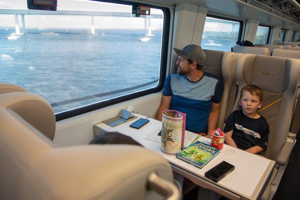 Caleb Cook and son Cohen, Reno, Nev. cross a bridge in Stuart, Fla., on the Brightline train to Orlando, Fla., on September 22, 2023. The family was on a Disney cruise in Miami and traveled to Orlando to visit the theme parks.