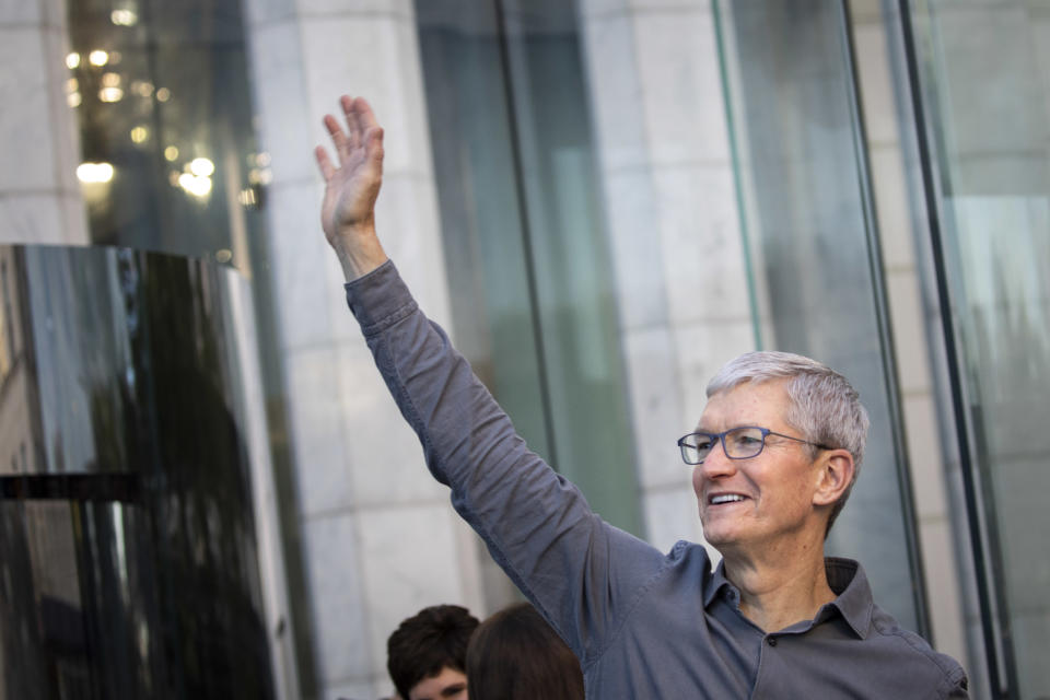 Apple CEO Tim Cook waves to customers before they enter Apple's flagship 5th Avenue store to purchase the new iPhone 11 on 20 September in New York City. Photo: Drew Angerer/Getty 