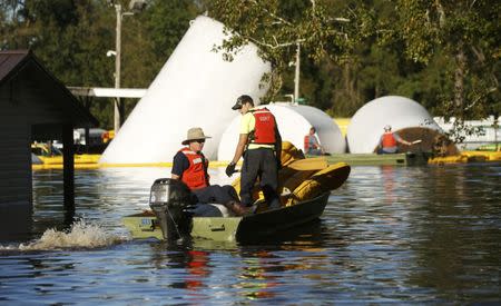 State Emergency Response Team (SERT) members work on containing municipal gasoline storage containers in floodwaters following Hurricane Matthew in Lumberton, North Carolina, U.S., October 10, 2016. REUTERS/Carlo Allegri