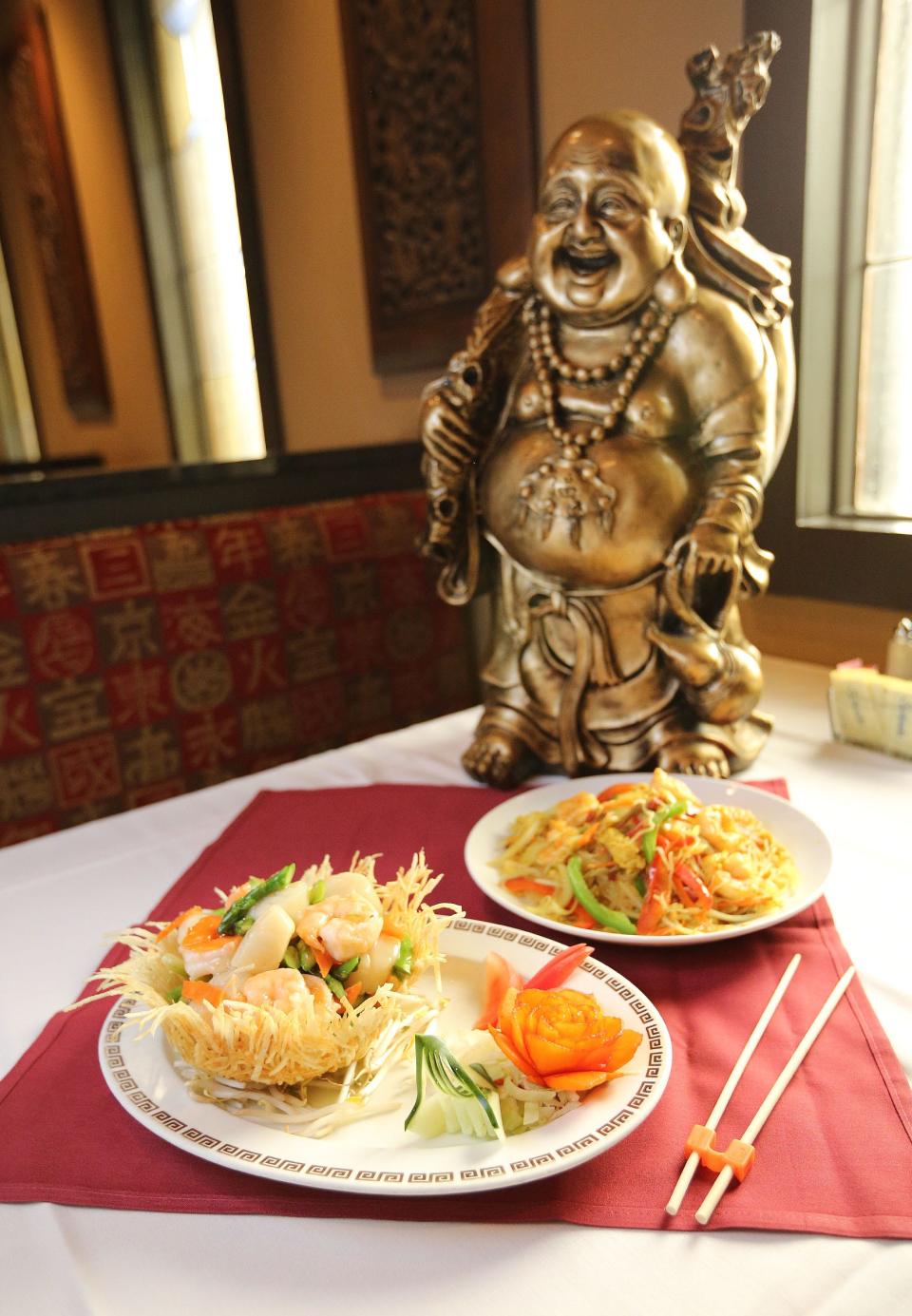 Asparagus, shrimp and scallops delight, left, and Singapore rice noodles from China Dynasty inside the Shops on Lane Avenue. The restaurant was open for 32 years until it closed in 2019.