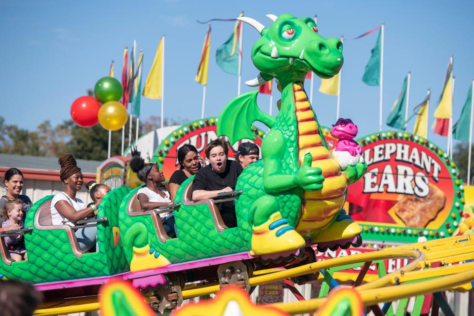 Visitors take a ride on the Dragon Flyer at the Pensacola Interstate Fair Sunday, October 23, 2022. The 2023 fair runs Oct. 19-29, 2023.