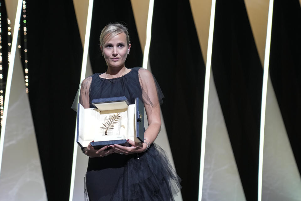 Director Julia Ducournau holds the Palme d'Or for the film 'Titane' during the awards ceremony at the 74th international film festival, Cannes, southern France, Saturday, July 17, 2021. (AP Photo/Vadim Ghirda)