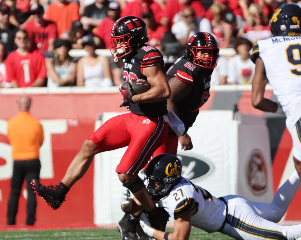 Utah Utes safety Sione Vaki (28) runs the ball against California Golden Bears linebacker Cade Uluave (27) in Salt Lake City on Saturday, Oct. 14, 2023. Utah won 34-14.