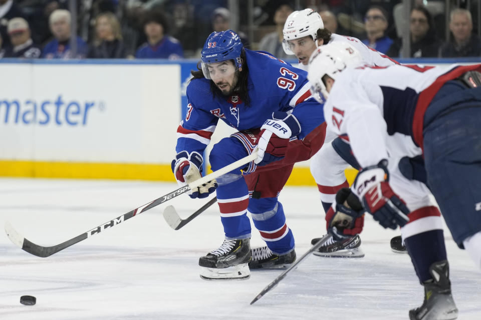 New York Rangers' Mika Zibanejad, left, chases the puck during the second period in Game 1 of an NHL hockey Stanley Cup first-round playoff series against the Washington Capitals, Sunday, April 21, 2024, in New York. (AP Photo/Seth Wenig)