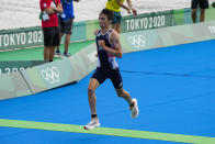 FILE - Alex Yee of Britain runs as he competes during the mixed relay triathlon at the 2020 Summer Olympics, Saturday, July 31, 2021, in Tokyo, Japan. (AP Photo/Eugene Hoshiko, File)