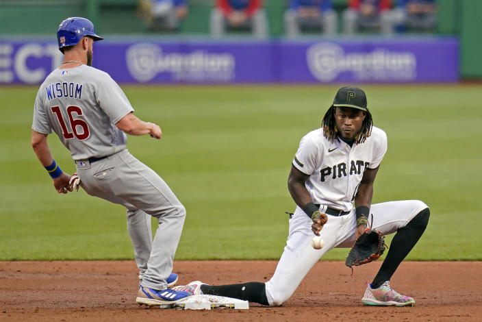 Pittsburgh Pirates shortstop Oneil Cruz, right, takes the late pick-off throw from starting pitcher JT Brubaker as Chicago Cubs' Patrick Wisdom (16) gets back to second safely during the second inning of a baseball game in Pittsburgh, Monday, June 20, 2022. (AP Photo/Gene J. Puskar)