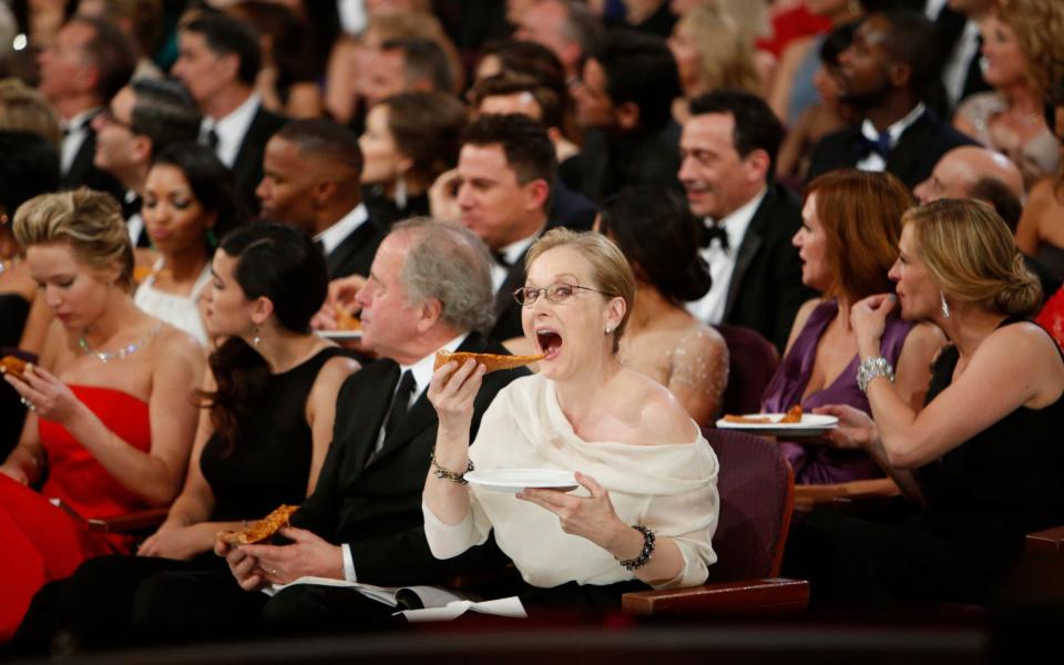 Meryl Streep tucking into pizza at the 2014 Oscars. when she was nominated for The Post