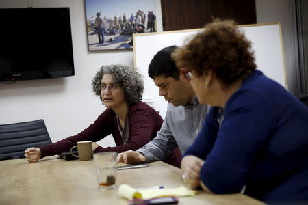 Yariv Oppenheimer (C), head of Peace Now, an Israeli NGO that tracks and opposes Jewish settlement in the occupied West Bank and East Jerusalem, takes part in a meeting at their offices in Tel Aviv January 31, 2016. Picture taken January 31, 2016. REUTERS/Baz Ratner