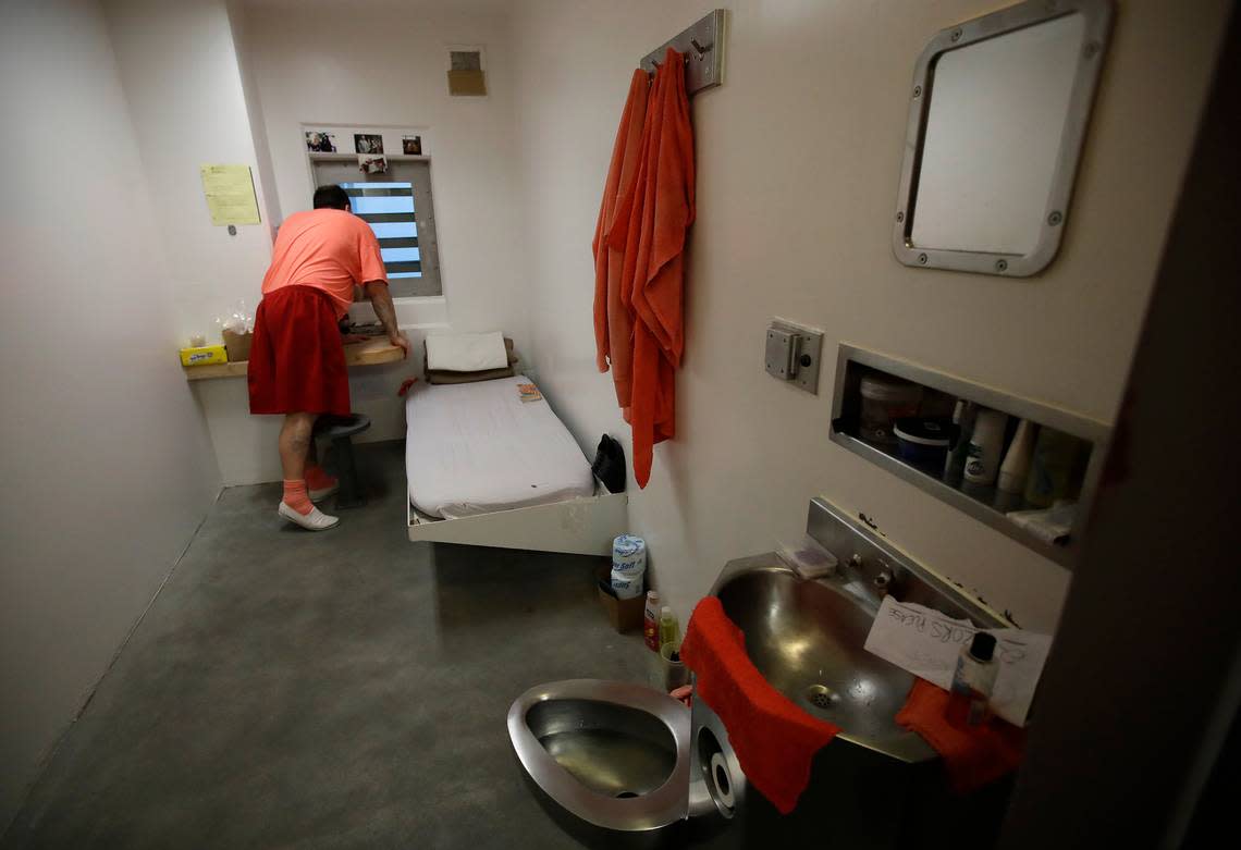 FILE - An inmate looks out a window in his solitary confinement cell at the Main Jail in San Jose, Calif., on Dec. 16, 2019. (AP Photo/Ben Margot, File)
