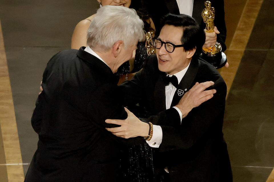 Ke Huy Quan (R) accepts the award for Best Picture for "Everything Everywhere All at Once" from Harrison Ford onstage during the 95th Annual Academy Awards at Dolby Theatre on March 12, 2023 in Hollywood, California.