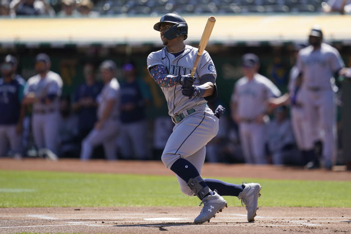 Seattle Mariners' Julio Rodriguez hits a double during the first inning of a baseball game against the Oakland Athletics in Oakland, Calif., Thursday, Sept. 22, 2022. (AP Photo/Jeff Chiu)
