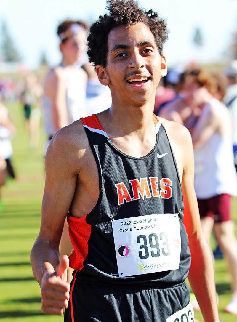 Ames junior Ahmed Aldamak (393) recovers after running the 4A boys race during the state co-ed cross country meet Saturday at the Lakeside Municipal Golf Course at Kennedy Park in Fort Dodge.