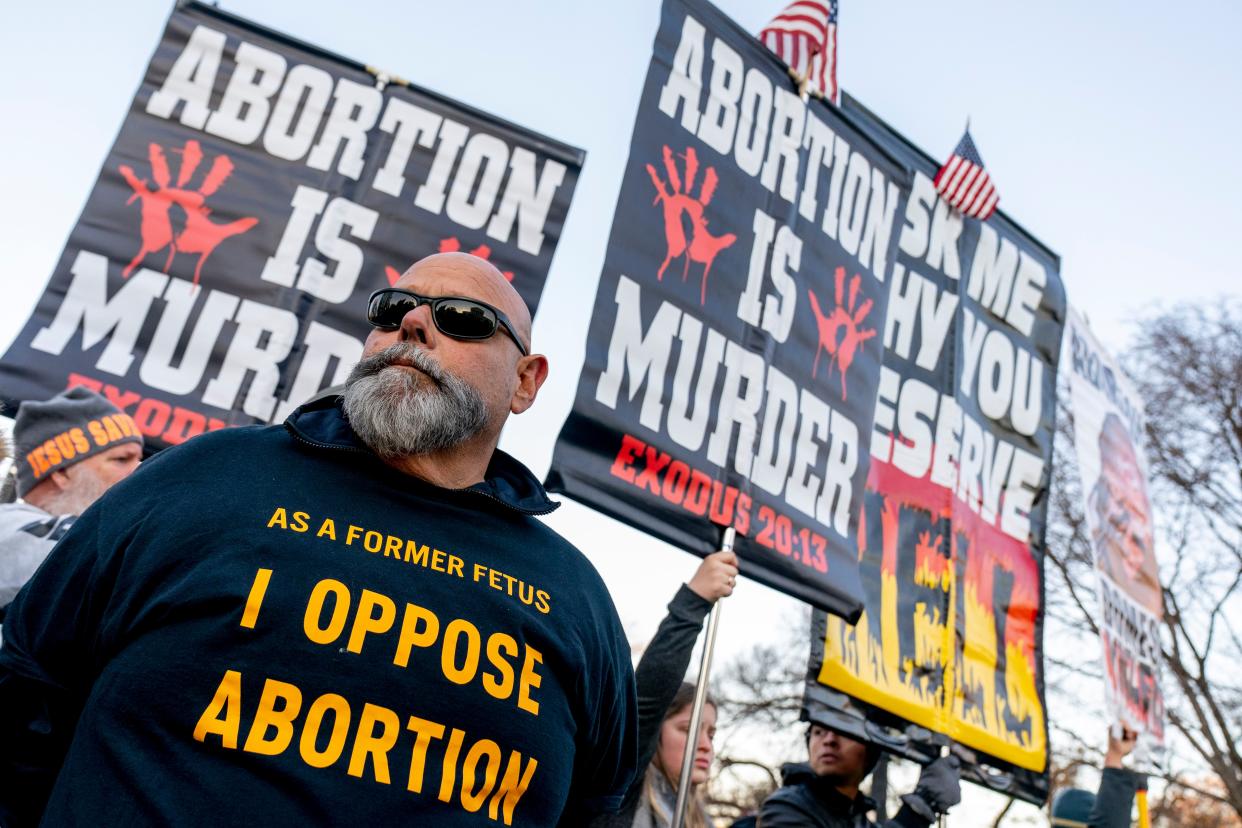 Anti-abortion protesters surround abortion rights advocates as both groups demonstrate in front of the Supreme Court, Wednesday, Dec. 1, 2021, in Washington, as the court hears arguments in an abortion case from Mississippi.