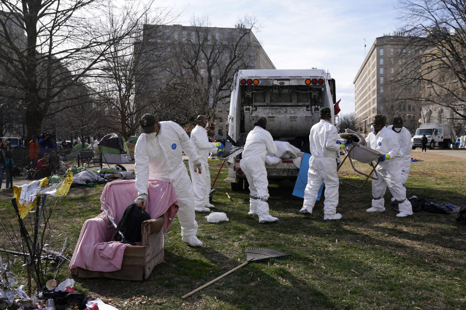 Workers clear a homeless encampment at McPherson Square in Washington, Wednesday, Feb. 15, 2023. (AP Photo/Patrick Semansky)