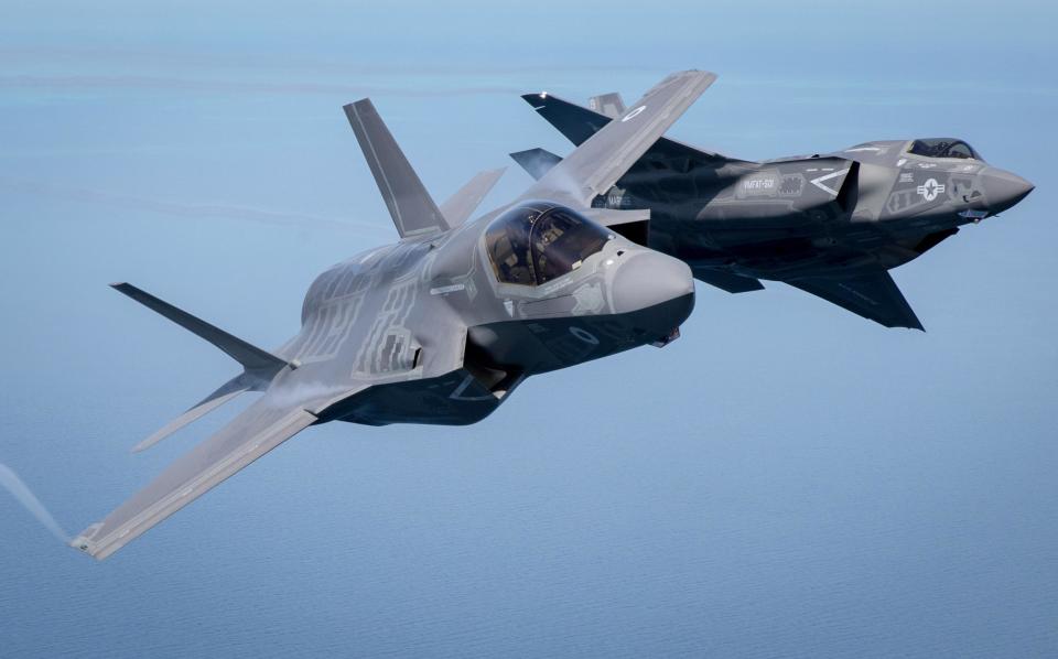 The first of Britain's new supersonic 'stealth' strike fighters accompanied by a United States Marine Corps F-35B aircraft take part in the Royal International Air Tattoo in 2016. (Getty)