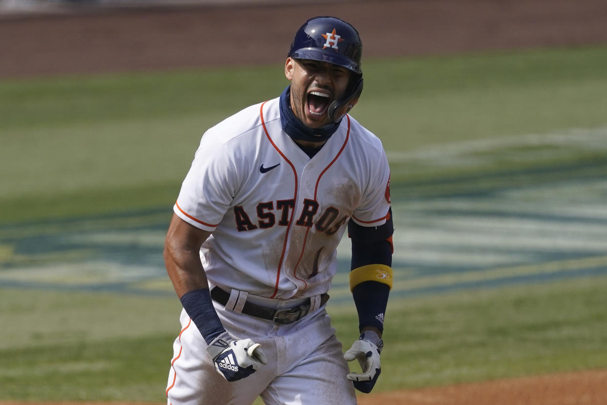 Houston Astros' Carlos Correa celebrates after hitting a three-run home run against the Oakland Athletics during the fourth inning of Game 4 of a baseball American League Division Series in Los Angeles, Thursday, Oct. 8, 2020. (AP Photo/Ashley Landis)