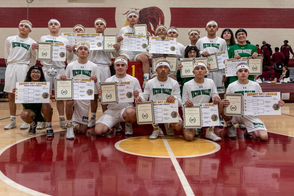 The Victor Valley wrestling team poses for a group photo at the Desert Sky League wrestling finals on Saturday, Jan. 21, 2023. Eleven boys and two girls captured league titles.