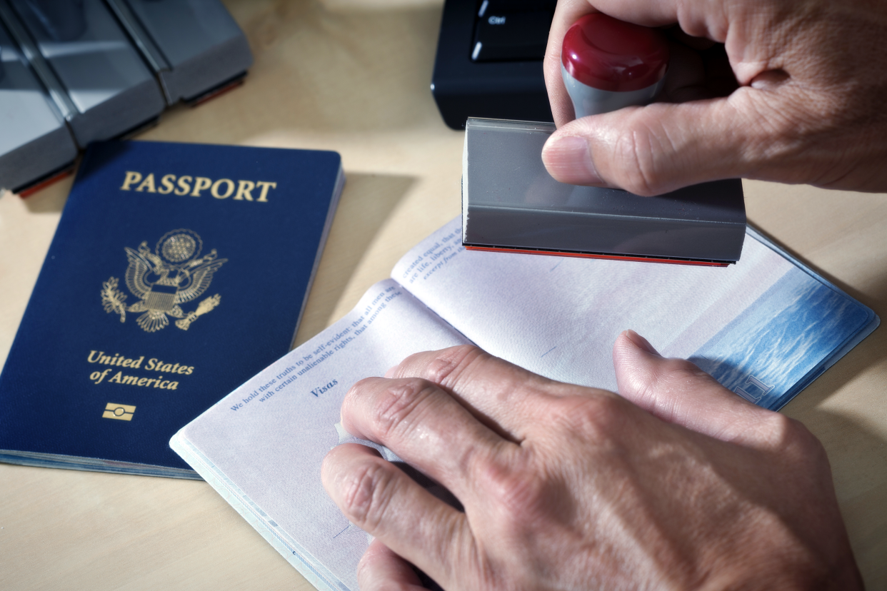 Border officer stamping a visa