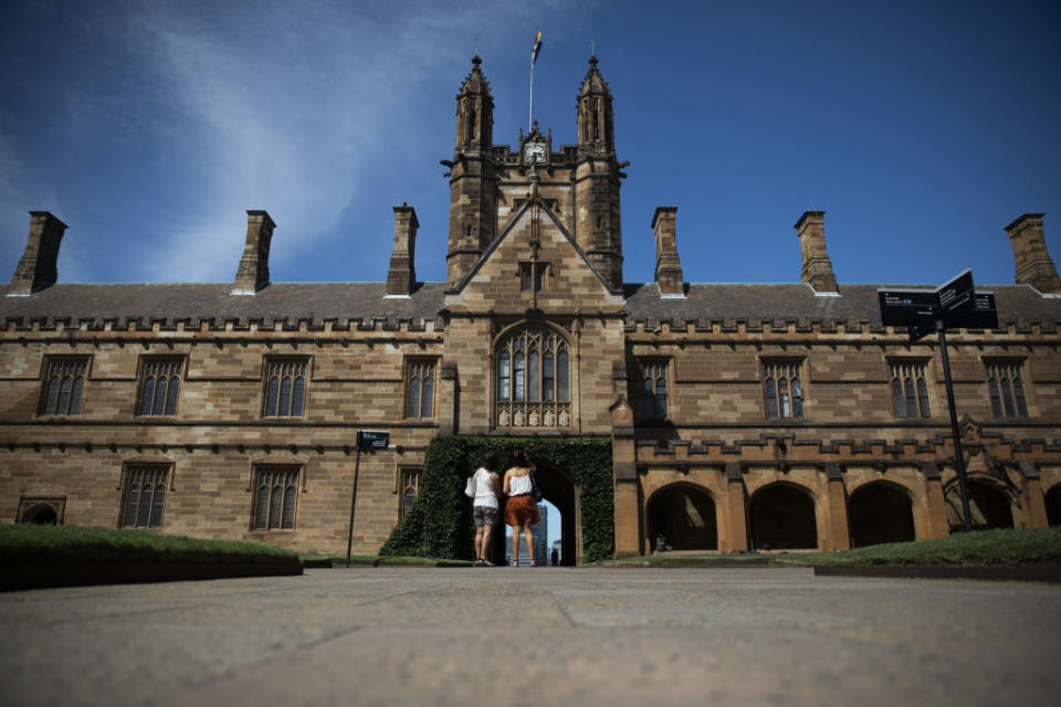 Two students stand in the University of Sydney&#39;s quad.