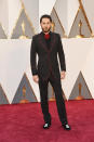 <p>Jared Leto brought Gucci designer Alessandro Michele as his date to the Oscars this year — and the duo brought surrealism to the red carpet. In an avant-garde tuxedo with red piping, serpentine velour slippers, and a festive floral tie, the actor looked characteristically stand-out.</p>