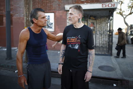 Los Angeles Superior Court Judge Craig Mitchell, 58, (L) congratulates Ben Shirley, 50, after a Midnight Mission Running Club sunrise run through Skid Row in Los Angeles, California April 16, 2015. REUTERS/Lucy Nicholson