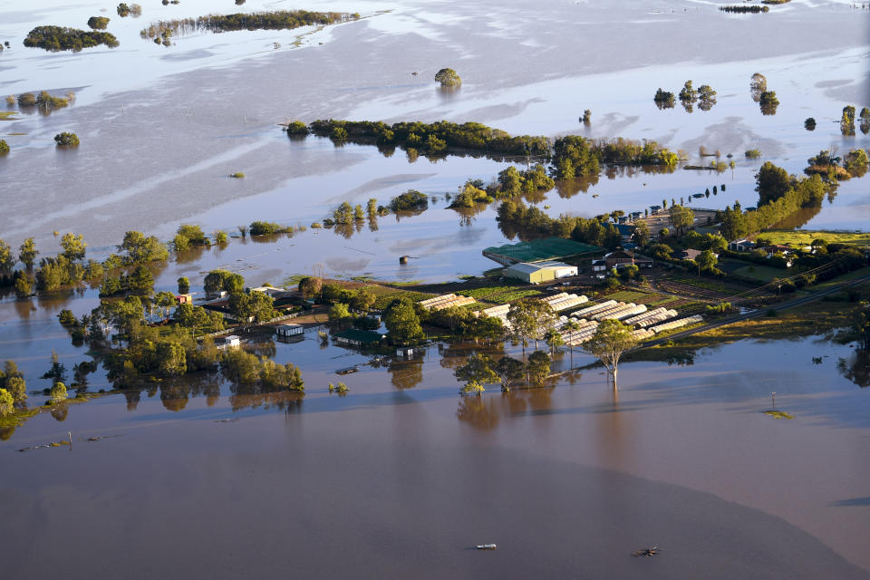 Buildings are partially submerged as floodwater covers large areas north west of Sydney, Australia, Wednesday, March 24, 2021. Some 18,000 residents of Australia's most populous state have fled their homes since last week, with warnings the flood cleanup could stretch into April. (Lukas Coch/Pool Photo via AP)