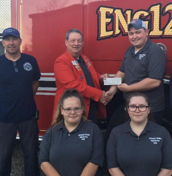 2020-21 Lions Vice District Gov. Kevin Reidy presents a $1,000 check to Lead Explorer Scott Engelhardt in April 2021.  Savannah Fire Chief Steve Dinsmore is on left, Explorers Averi Dunivan and Quinn Louk are in front from left.