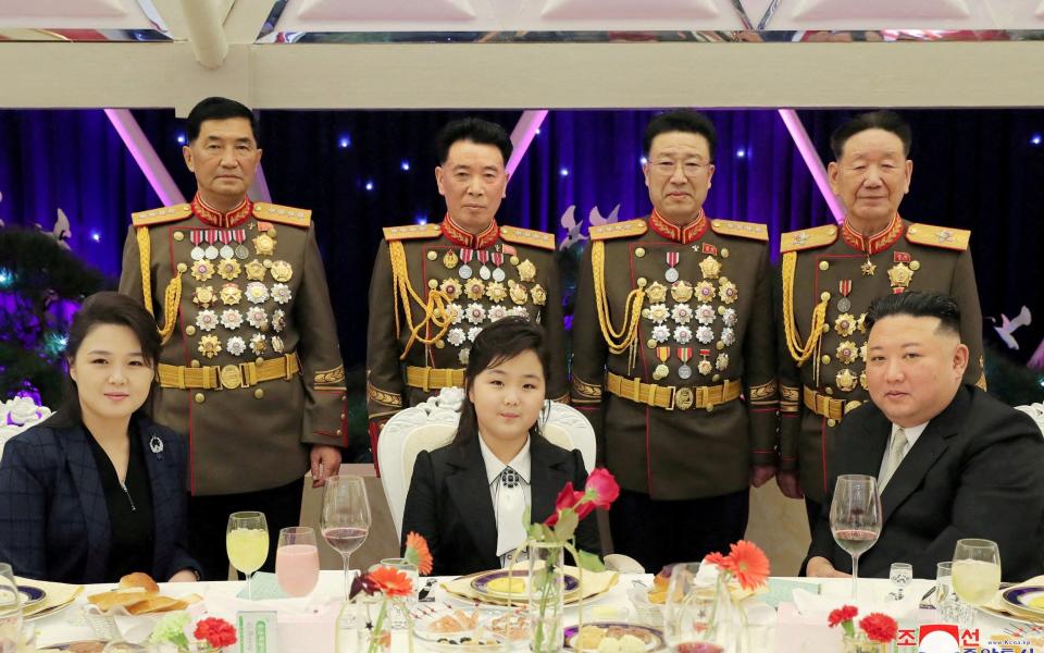 Kim Jong-un, his wife Ri Sol Ju, left, and their daughter Kim Ju-ae. The North Korean leader's wife is seen wearing a missile-shaped pendant - KCNA/Reuters