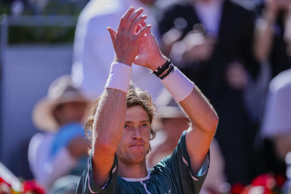 Andrey Rublev, of Russia, applauds after winning a match against Taylor Fritz, of United States, during the Mutua Madrid Open tennis tournament in Madrid, Spain, Friday, May 3, 2024. (AP Photo/Bernat Armangue)