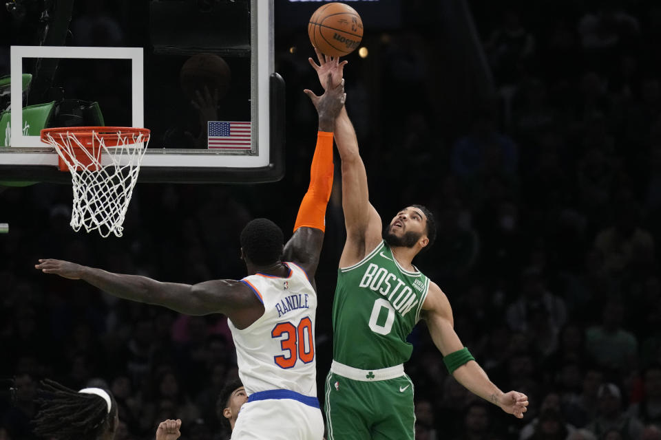 Boston Celtics forward Jayson Tatum (0) blocks a shot by New York Knicks forward Julius Randle (30) during the first half of an NBA basketball game, Friday, Dec. 8, 2023, in Boston. (AP Photo/Charles Krupa)