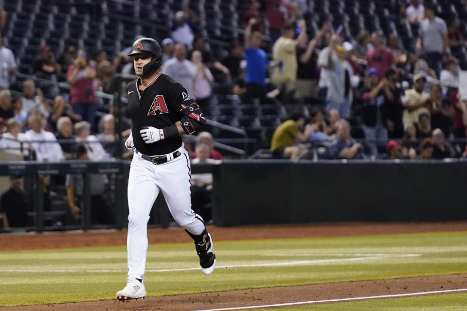 Arizona Diamondbacks' Christian Walker rounds the bases after hitting a home run against the Colorado Rockies during the fifth inning of a baseball game Wednesday, May 31, 2023, in Phoenix. (AP Photo/Ross D. Franklin)