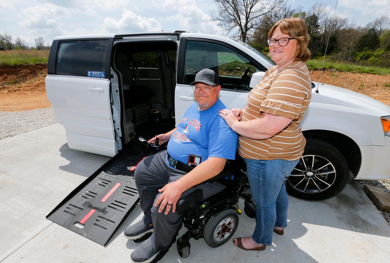 Jason Wendlandt and his wife Ashley next to his handicap-accessible van after a car accident last fall that left him paralyzed from the waist down.
