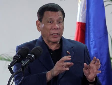 Philippine President Rodrigo Duterte interacts with reporters during a news conference upon his arrival from a four-day state visit in China at the Davao International Airport in Davao city, Philippines October 22, 2016. REUTERS/Lean Daval