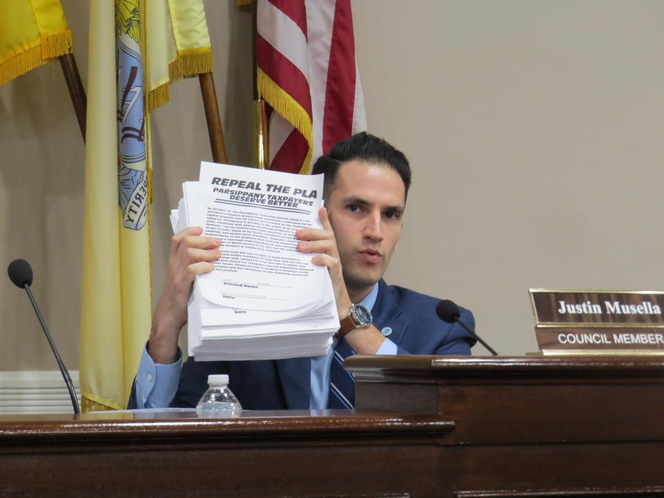 Parsippany councilman Justin Musella holds a printout of a petition he circulated online which drew more than 1,000 signatures urging the council to repeal a project labor agreement ordinance passed last year during the council's annual reorganization meeting.