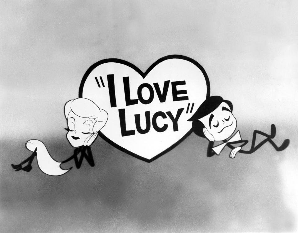 Cartoon characters of Lucille Ball and Desi Arnaz lean against a heart with "I Love Lucy" written inside