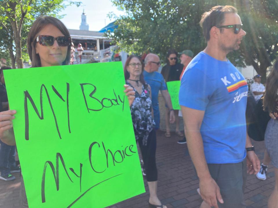 Actress Jennifer Van Dyck of New York City shows her support of abortion rights in the Friday evening crowd in front of Provincetown Town Hall, prior to an abortion rights rally.