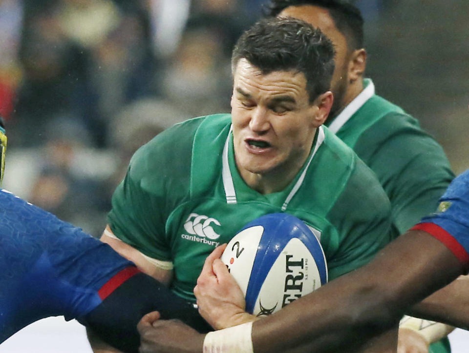 FILE - In this file photo dated Saturday, Feb. 3, 2018, Ireland's Jonathan Sexton, is caught by France players during their Six Nations rugby union match at the Stade de France stadium in Saint-Denis, outside Paris, France. Sexton on Monday Nov. 12, 2018, said he supports Conor Murray's "smart" call not to make Ireland's showdown with the All Blacks upcoming weekend his first match in five months after suffering a neck injury. (AP Photo/Michel Euler, FILE)