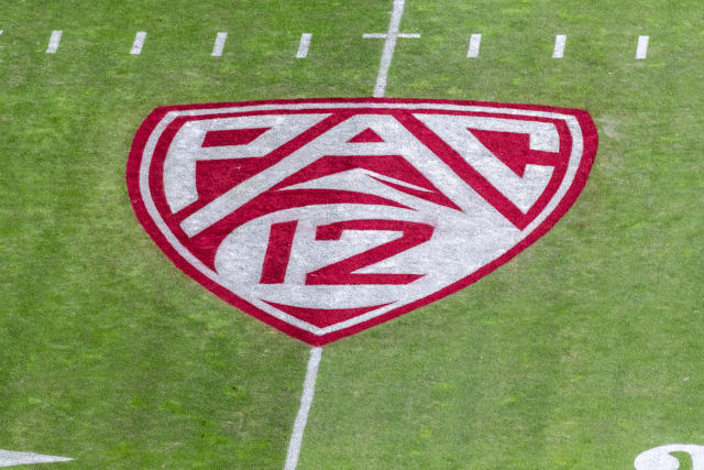 The PAC-12 logo on a football field.