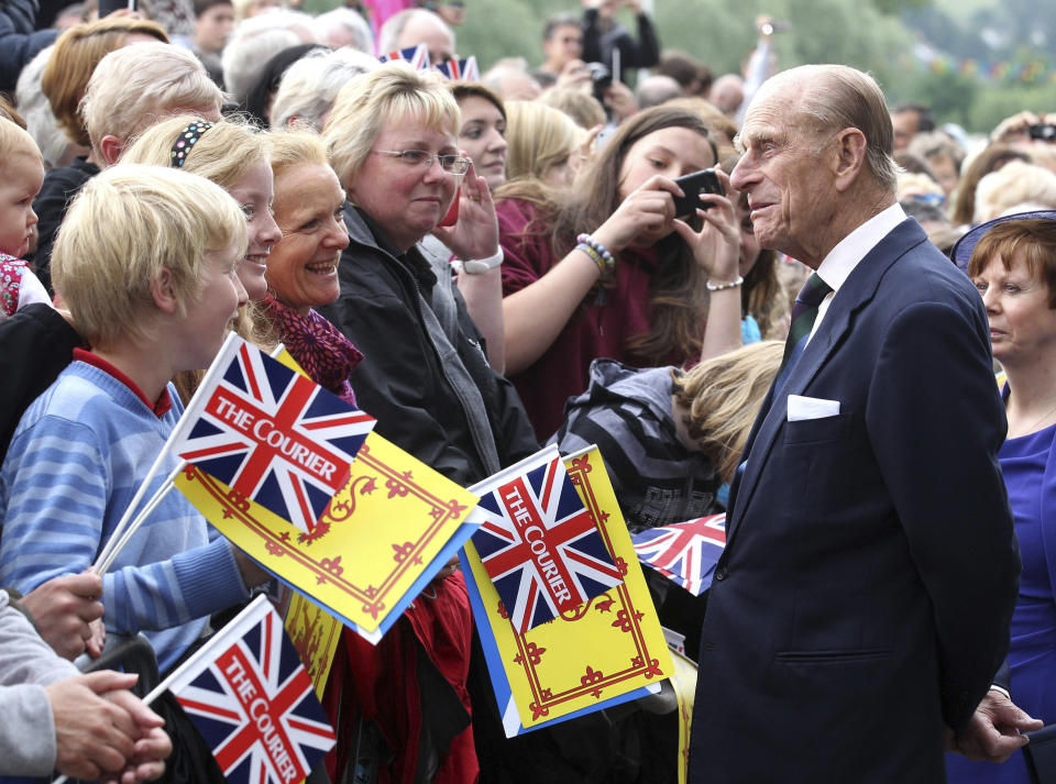 FILE - In this June 7, 2012 file photo, Britain's Prince Philip greets well wishers as he arrives in Perth, Scotland. Prince Philip, the irascible and tough-minded husband of Queen Elizabeth II who spent more than seven decades supporting his wife in a role that both defined and constricted his life, has died, Buckingham Palace said Friday, April 9, 2021. He was 99. (Andrew Milligan/PA via AP)