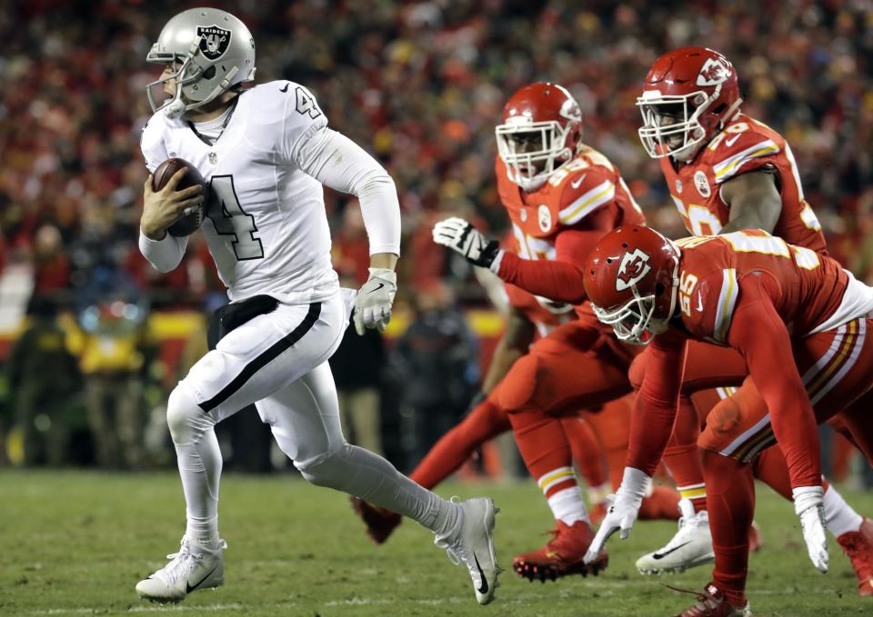 Oakland Raiders QB Derek Carr, left, took a hit to his MVP candidacy Thursday night. (AP)